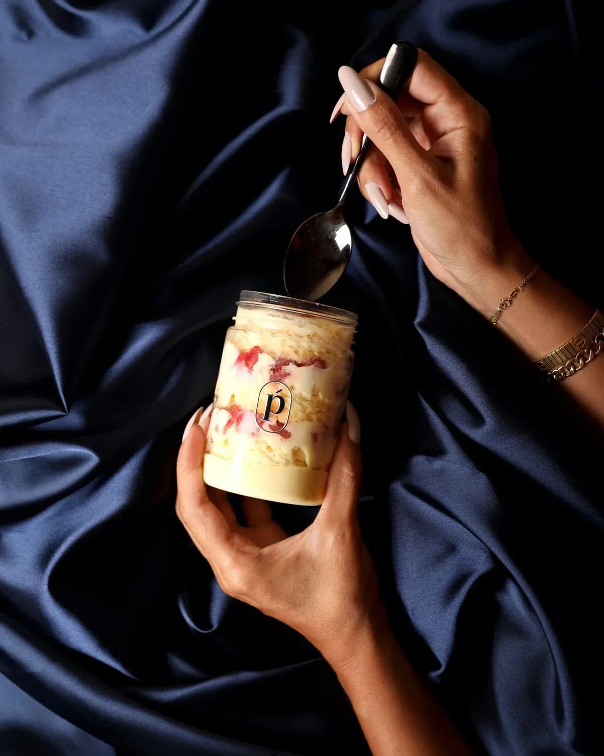 Fraisier, held, with a spoon.